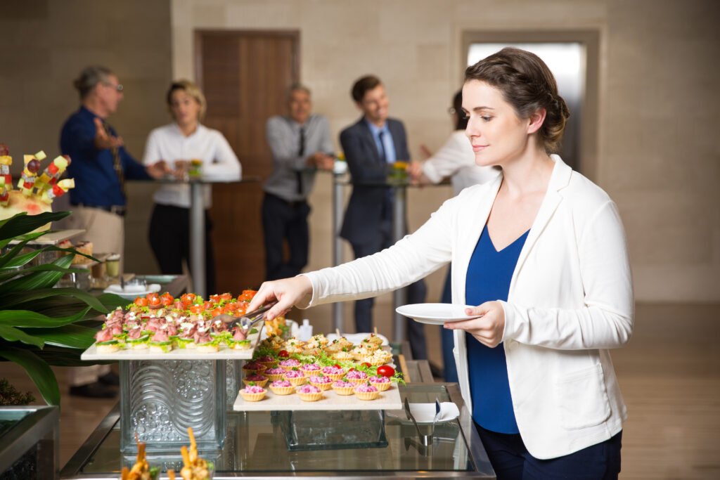 Businesswoman Serving Herself in Buffet Restaurant